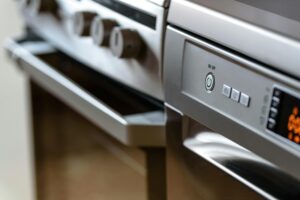 pexels-photo-213162-213162 Close-up view of modern stainless steel kitchen appliances with focus on dishwasher and oven.