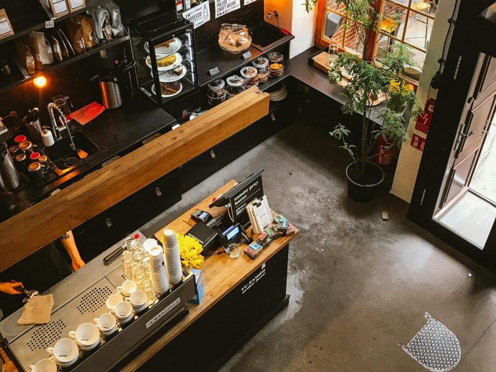 pexels-photo-2199190-2199190 High angle view of a modern coffee shop interior with a wooden counter and cozy furnishings, ideal for business and leisure.