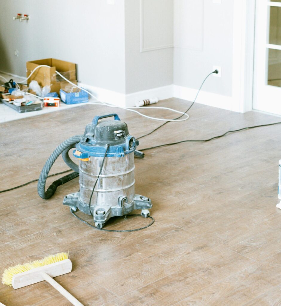 pexels-photo-3616746-3616746 Vacuum and tools in a room undergoing renovation, showcasing home improvement.