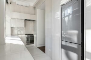 pexels-photo-8146159-8146159 Bright and sleek modern kitchen with stainless steel appliances and minimalist design.