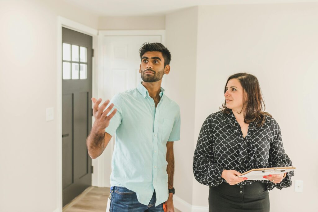 pexels-photo-8293747-8293747 A real estate agent tours a home with a potential buyer, showcasing property features.