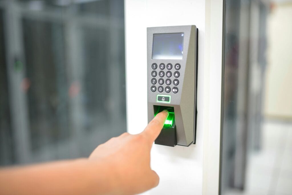 pexels-photo-17155842-17155842 A person uses a fingerprint scanner for secure entry in a business setting.