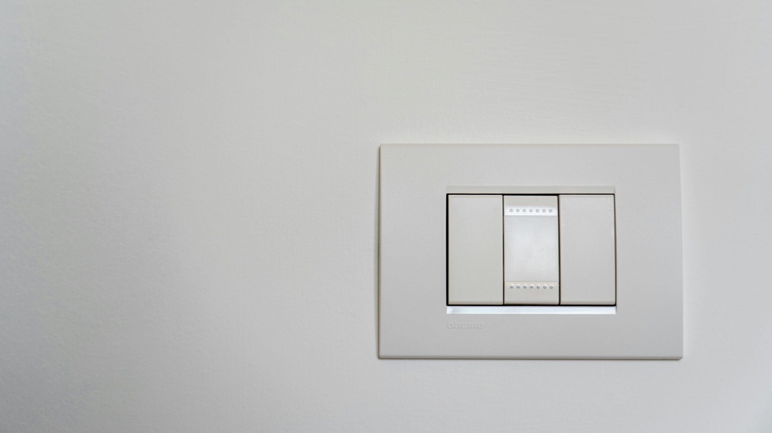 pexels-photo-3650908-3650908 Close-up of a modern white light switch on a clean wall.