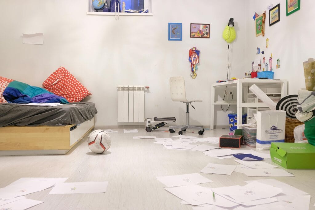 pexels-photo-4046082-4046082 Messy kids' room with scattered papers and toys, showing lively disorder.