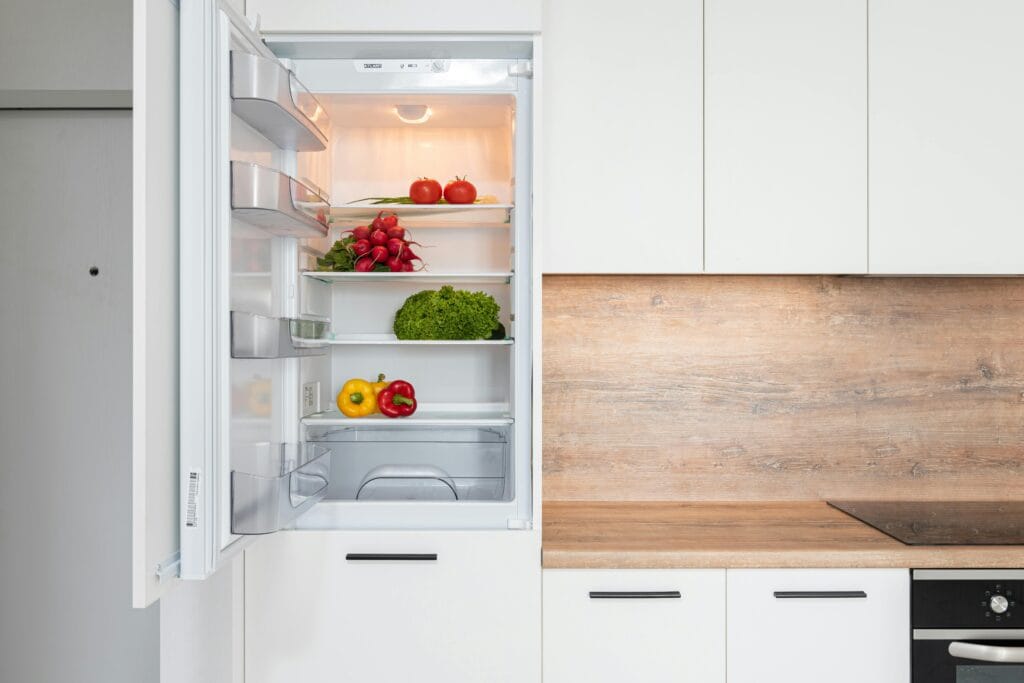 pexels-photo-6508357-6508357 Open fridge in a sleek kitchen with fresh vegetables, perfect for healthy meals.