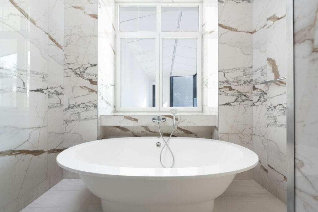 pexels-photo-8146153-8146153 Luxurious marble bathroom featuring a sleek freestanding bathtub and modern design elements.