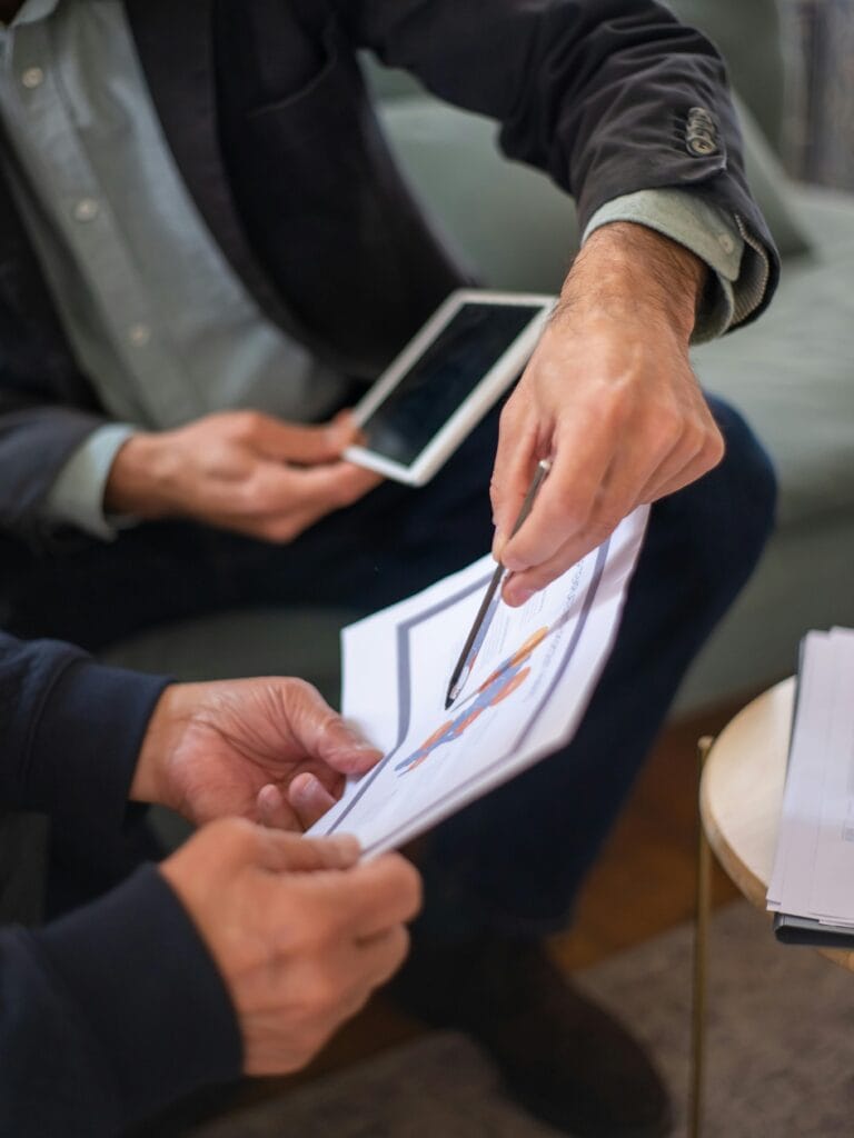 accountant Two professionals in a business meeting discussing documents and a tablet.