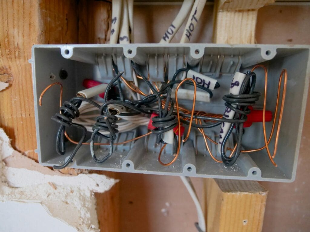 pexels-photo-8488029-8488029 Detailed view of an open electrical switchboard with tangled wires and cables.